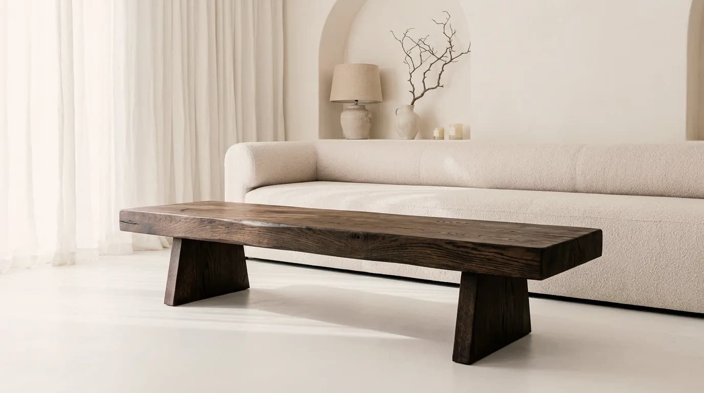 Furniture example made with Vizera: low smoked oak bench with wedge-shaped legs – also in light oak and in front of an olive green sofa.